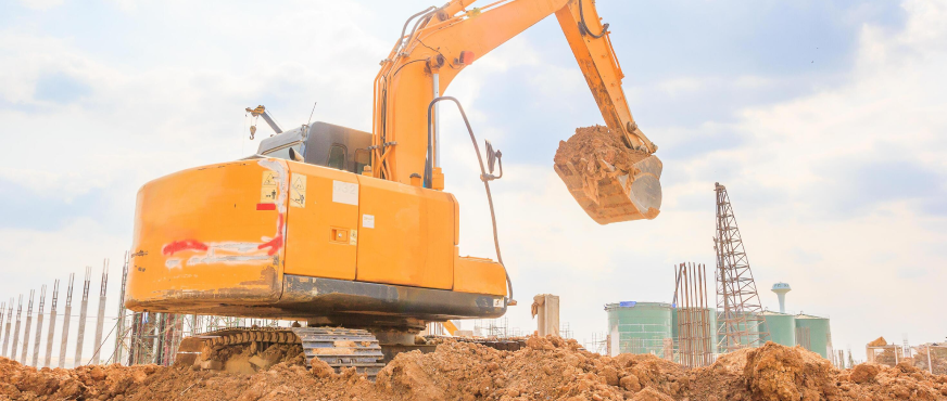 Excavator lifting soil during professional bulk earth removal and excavation services in New Jersey.