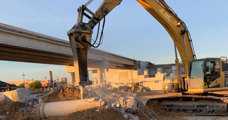 Heavy duty hydraulic breaker excavator sectioning a reinforced concrete slab for removal by P&E Demolition
