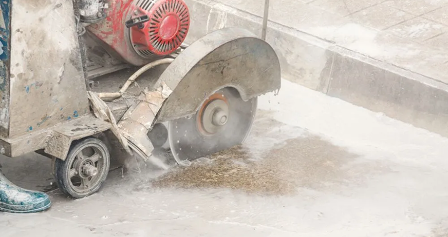 Concrete cutting machine with circular blade in operation during professional concrete cutting services in New Jersey.