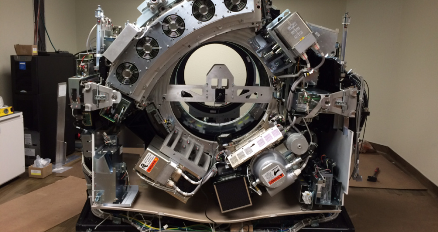 CT scanner dismantled with exposed internal components during professional industrial equipment and plant removal services in New Jersey