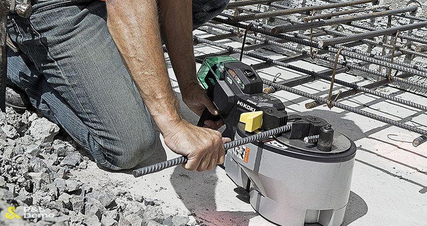 Worker using electric rebar cutter to cut steel reinforcement bars during professional rebar cutting and removal services in New Jersey.