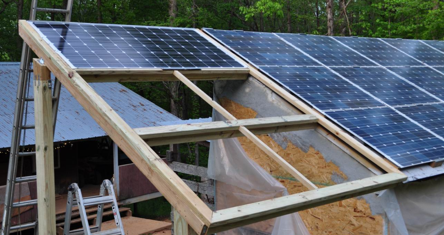 Solar panels mounted on a slanted wooden frame being dismantled during professional solar frame removal in New Jersey