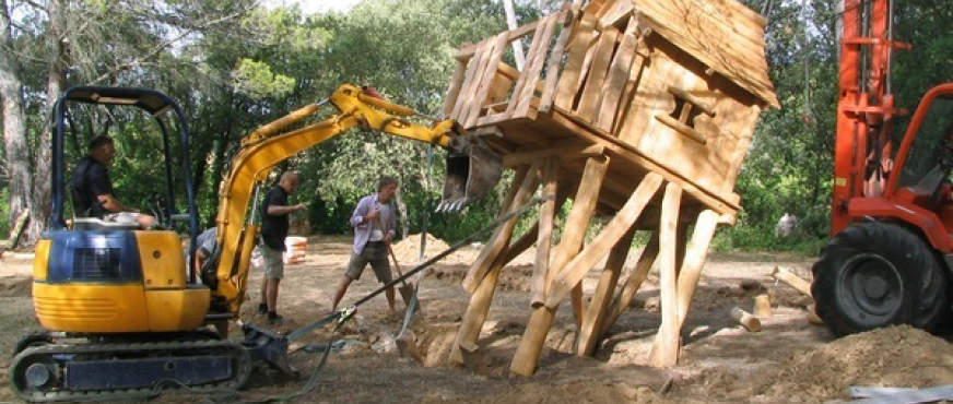 Excavator dismantling wooden treehouse structure during professional playhouse demolition services in New Jersey.