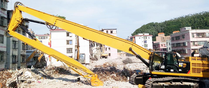 CAT high‑reach excavator demolishing multi‑story building during professional high‑reach arm demolition services in New Jersey.