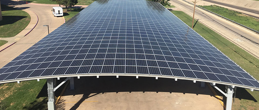 Large solar panel array mounted on a metal carport structure in New Jersey, prepared for professional dismantling and removal.