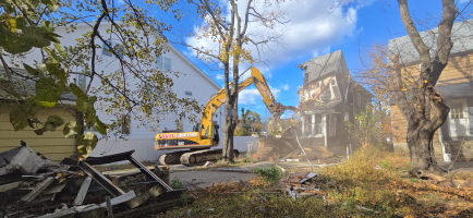 Excavator tearing down two‑story house during professional residential demolition services in New Jersey