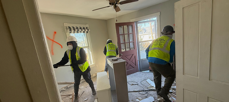 Construction workers dismantling interior wall partition during professional wall partition demolition services in New Jersey.