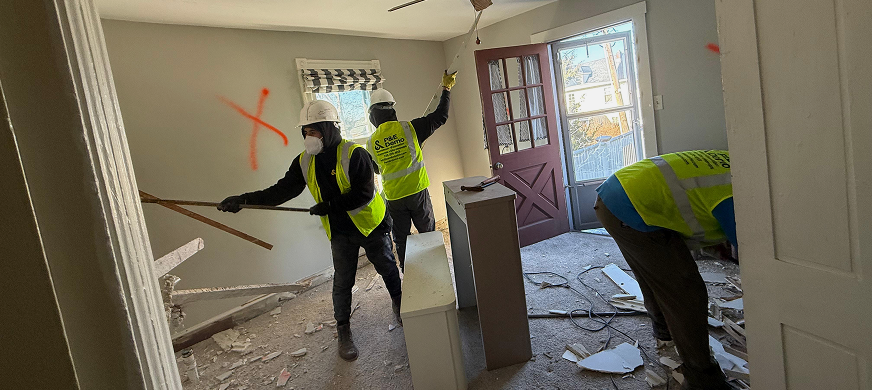 Construction workers dismantling interior wall partition during professional wall partition demolition services in New Jersey.